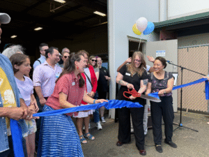 Executive Director Anna and Furniture Bank Manager Amber, cut the opening ribbon!